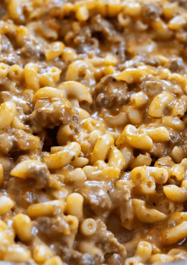 Creamy macaroni and cheese with ground beef, featuring a savory sauce for delicious comfort food.