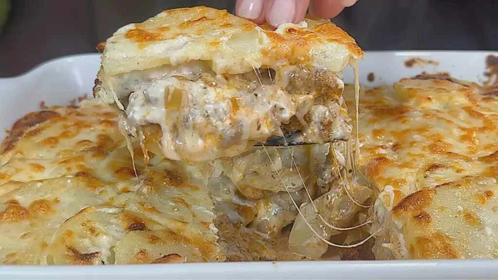 Cheesy beef and potato casserole served hot in a baking dish, topped with melted golden cheese.